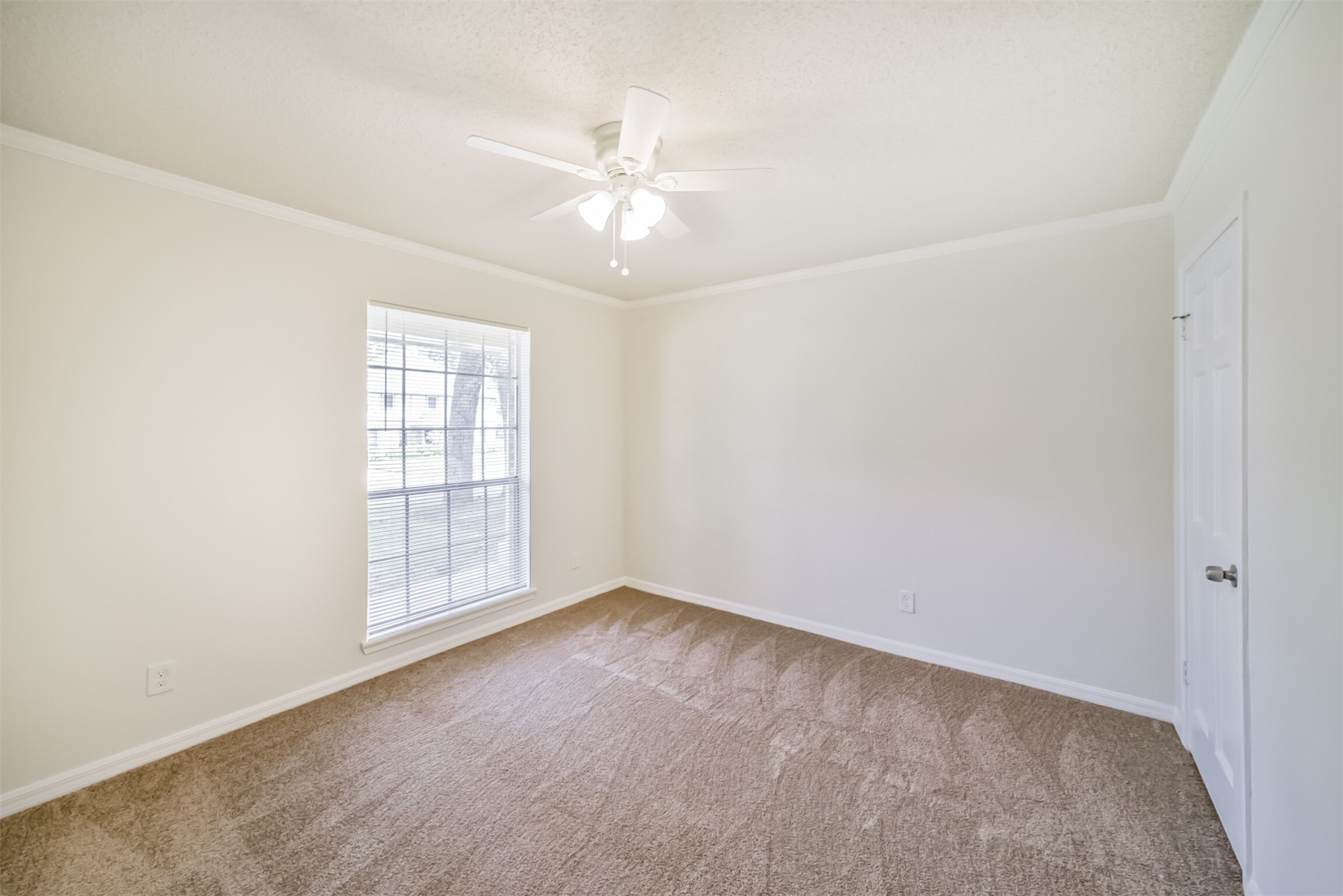 1011 Baltic Lane Houston, TX 77090 - Photo 20 of 43 an empty room with windows and fan chandelier