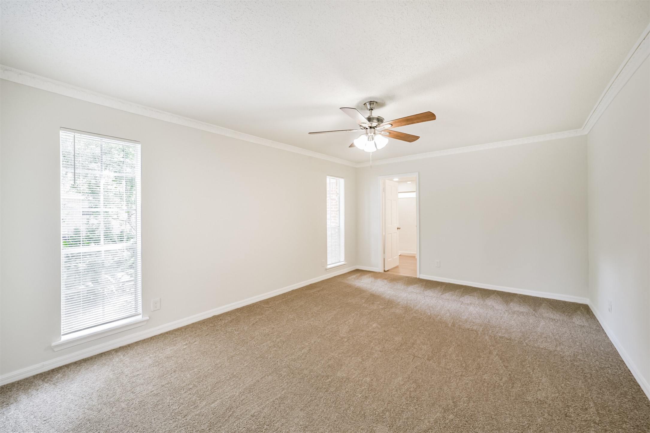 1011 Baltic Lane Houston, TX 77090 - Photo 24 of 43 an empty room with windows and fan
