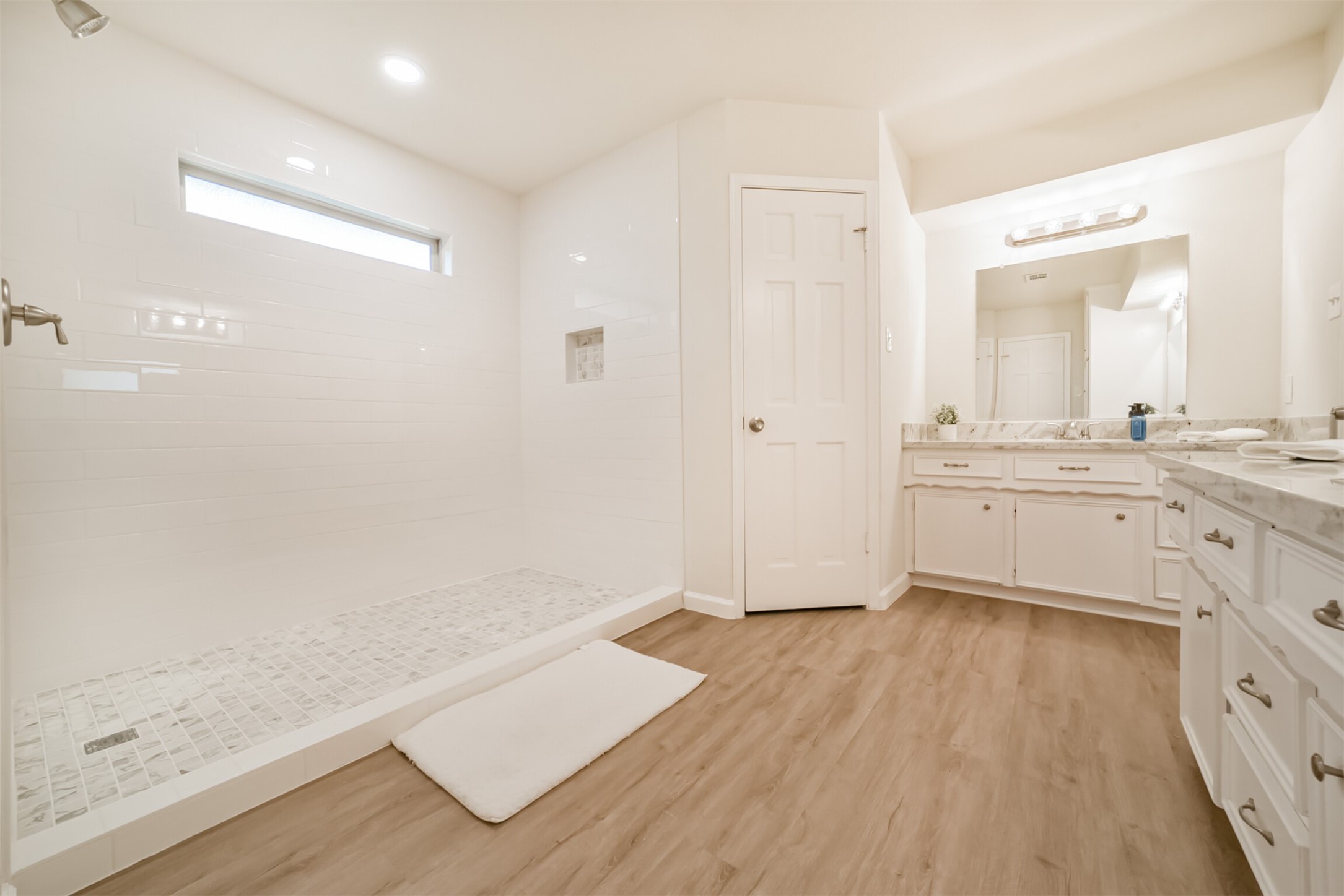 1011 Baltic Lane Houston, TX 77090 - Photo 28 of 43 a view of a kitchen with wooden floor and white cabinets