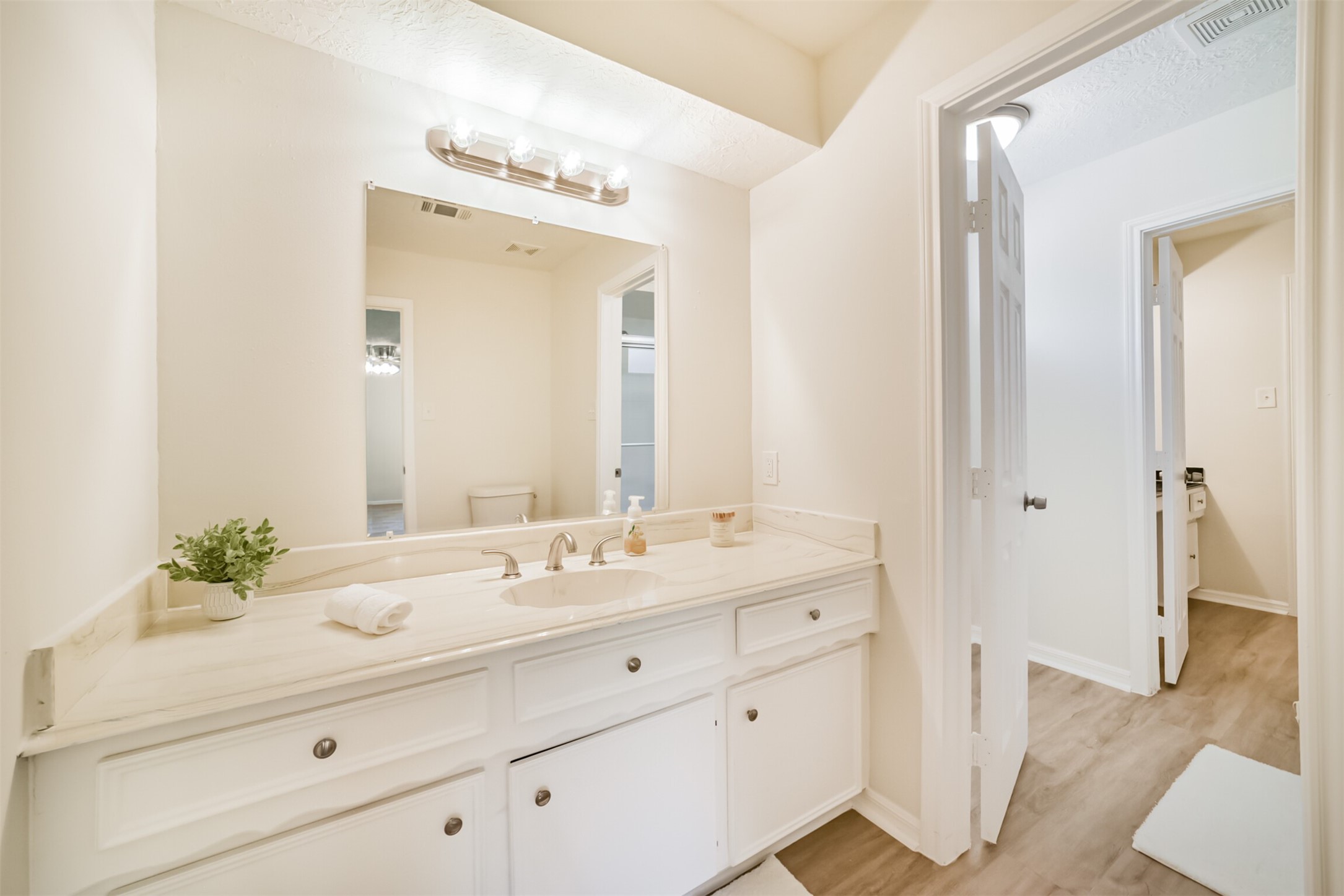 1011 Baltic Lane Houston, TX 77090 - Photo 31 of 43 a bathroom with a sink vanity granite and a mirror