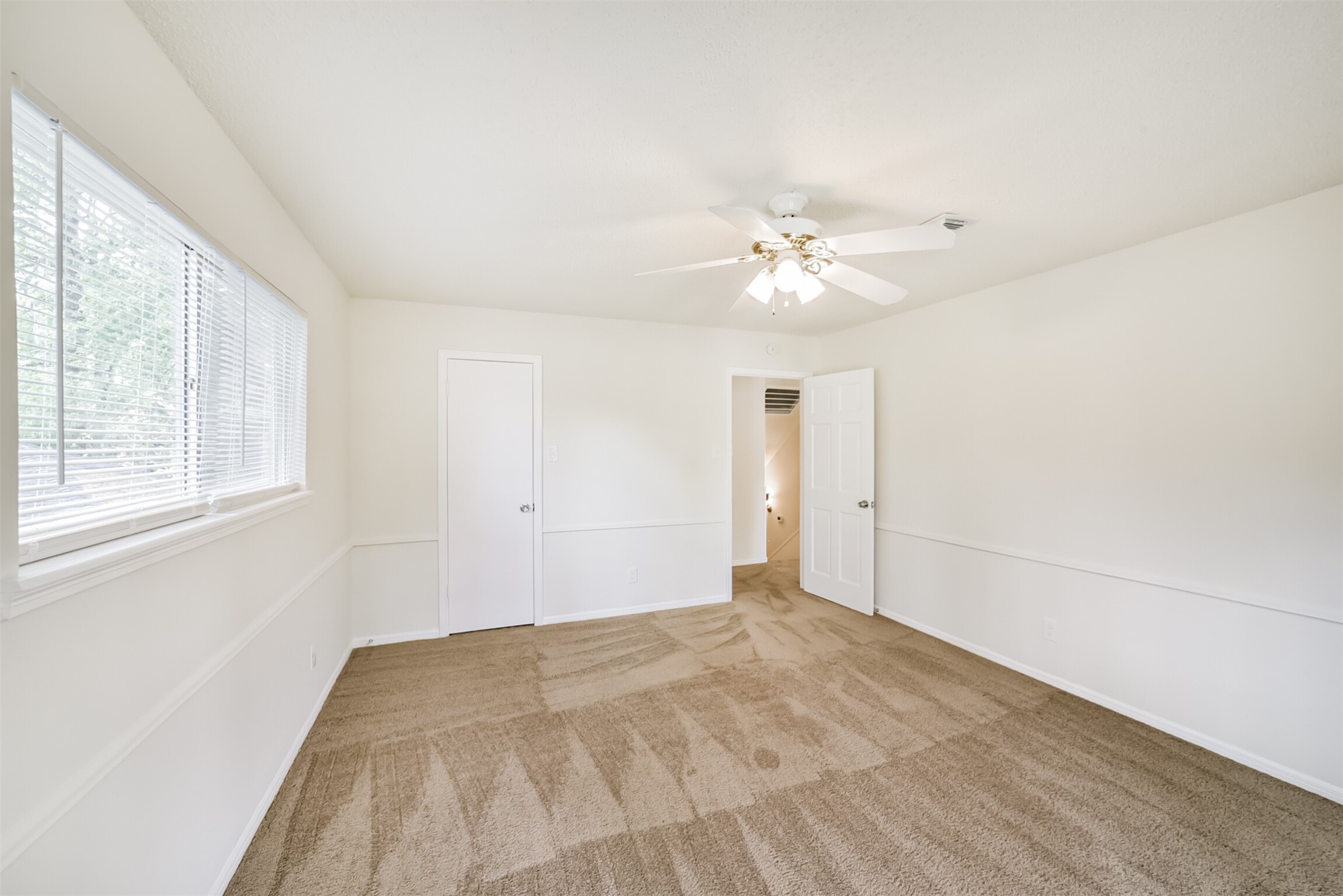 1011 Baltic Lane Houston, TX 77090 - Photo 39 of 43 a view of a room with a ceiling fan and a window