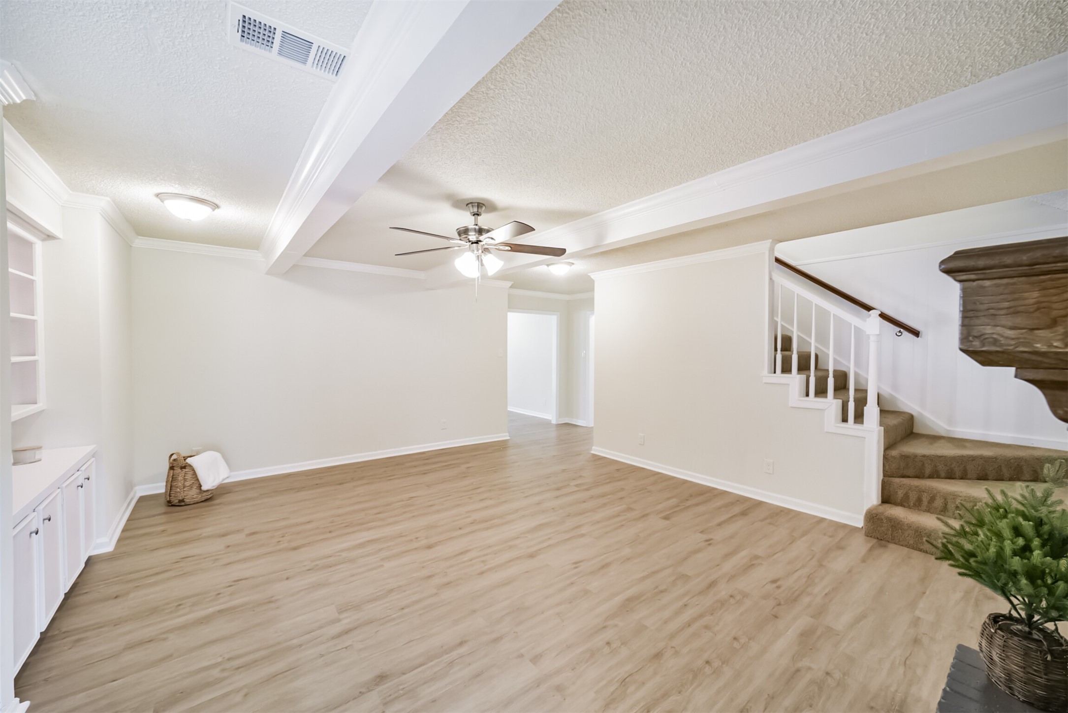 1011 Baltic Lane Houston, TX 77090 - Photo 5 of 43 a view of an empty room with wooden floor and a ceiling fan