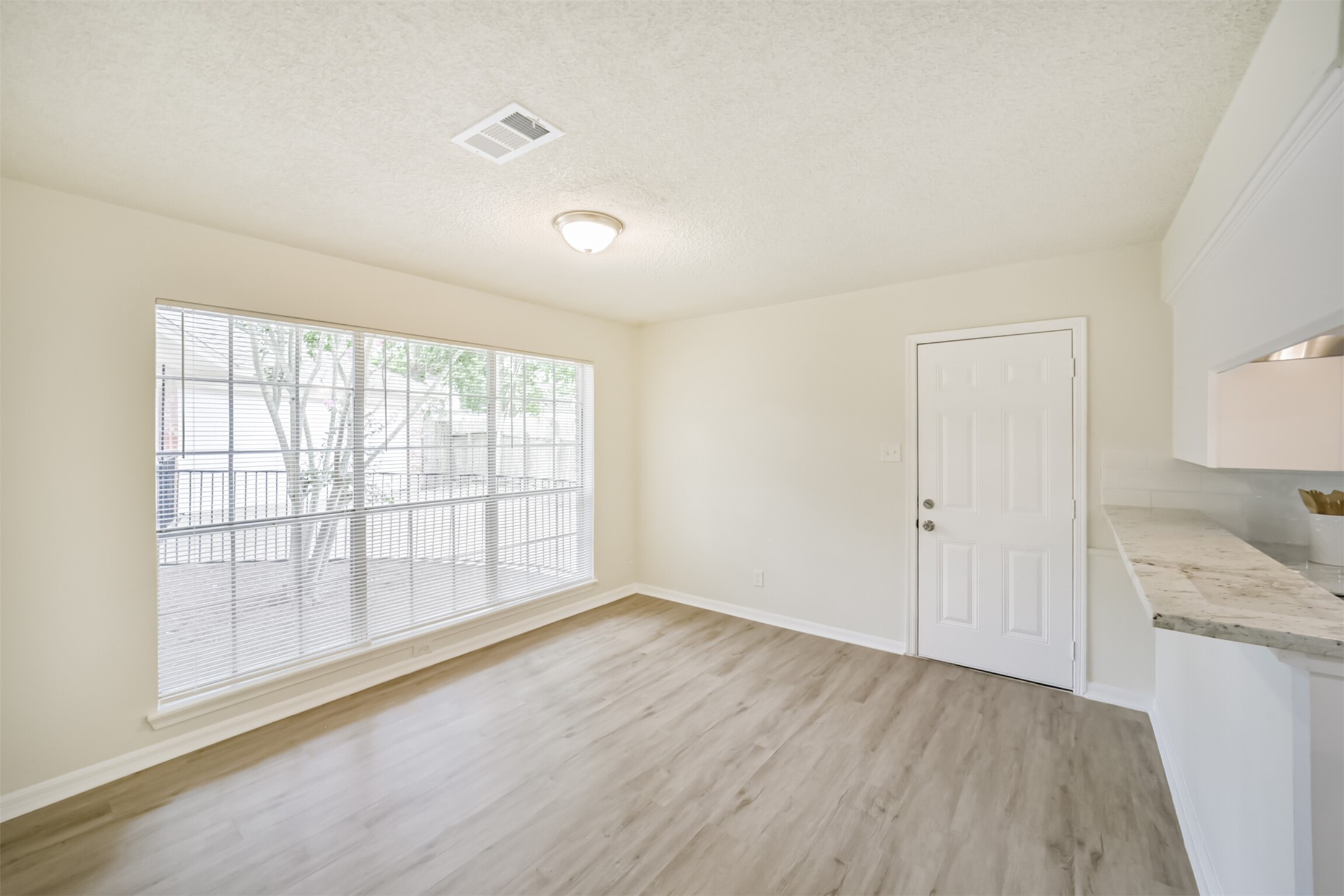 1011 Baltic Lane Houston, TX 77090 - Photo 9 of 43 wooden floor in an empty room with a window