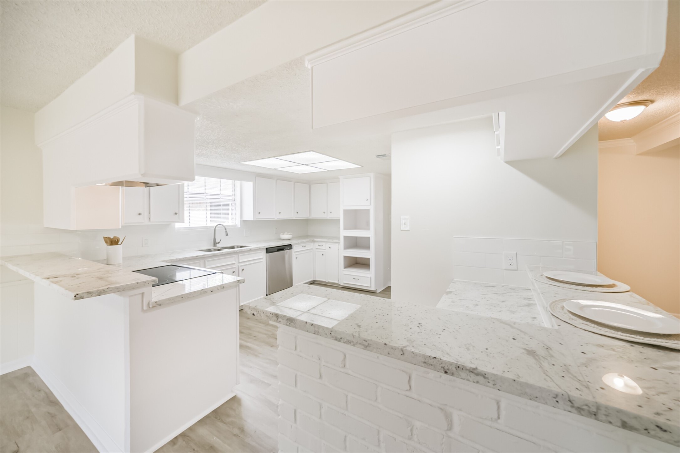1011 Baltic Lane Houston, TX 77090 - Photo 10 of 43 a kitchen with a sink cabinets and wooden floor