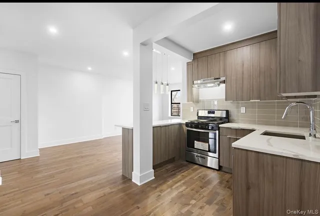 a kitchen with a sink cabinets and stainless steel appliances