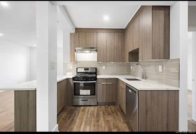 a kitchen with a sink appliances and cabinets
