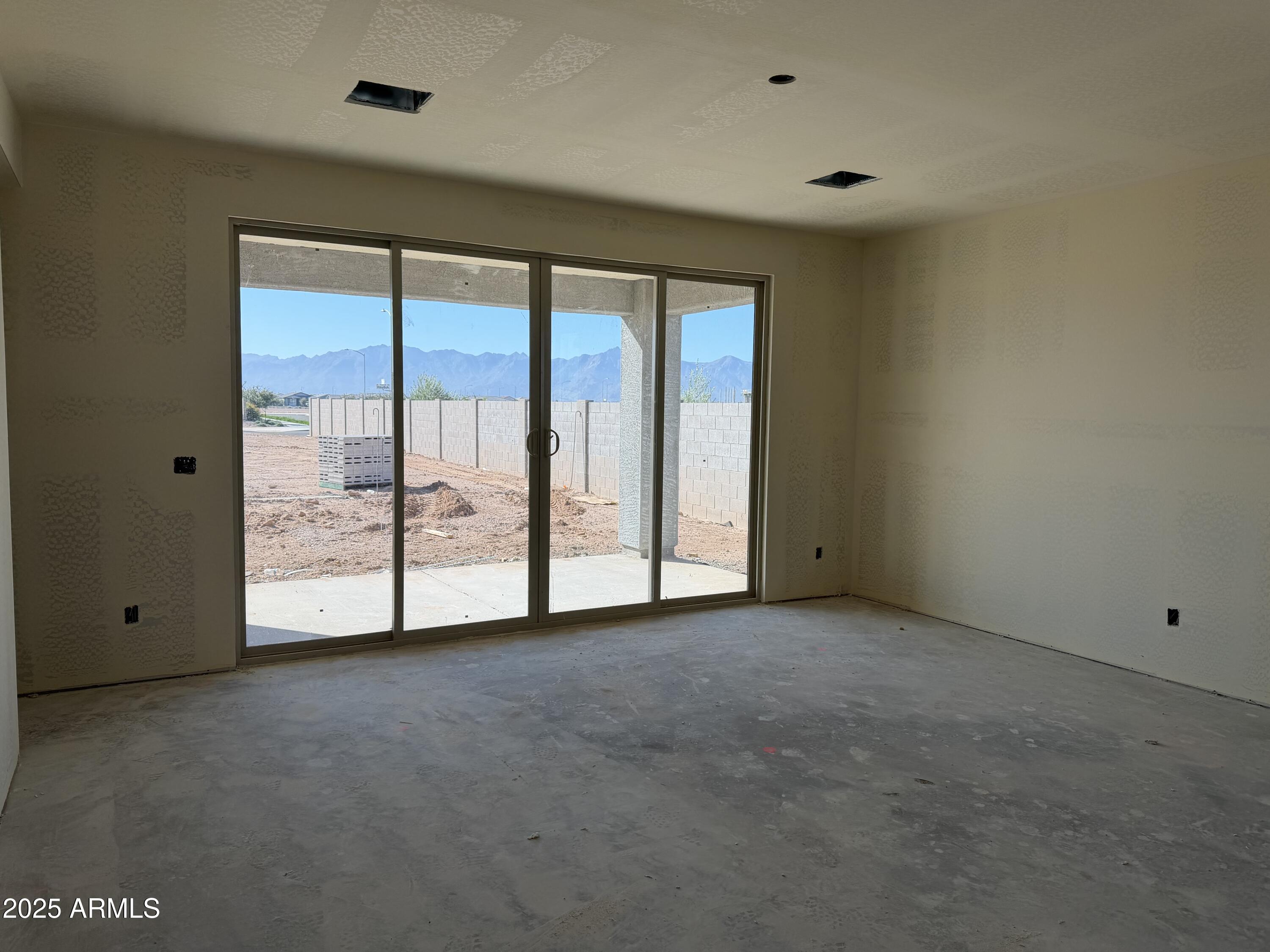 5613 West Hopi Trail Laveen, AZ 85339 - Photo 8 of 25 a view of an empty room with a sliding door