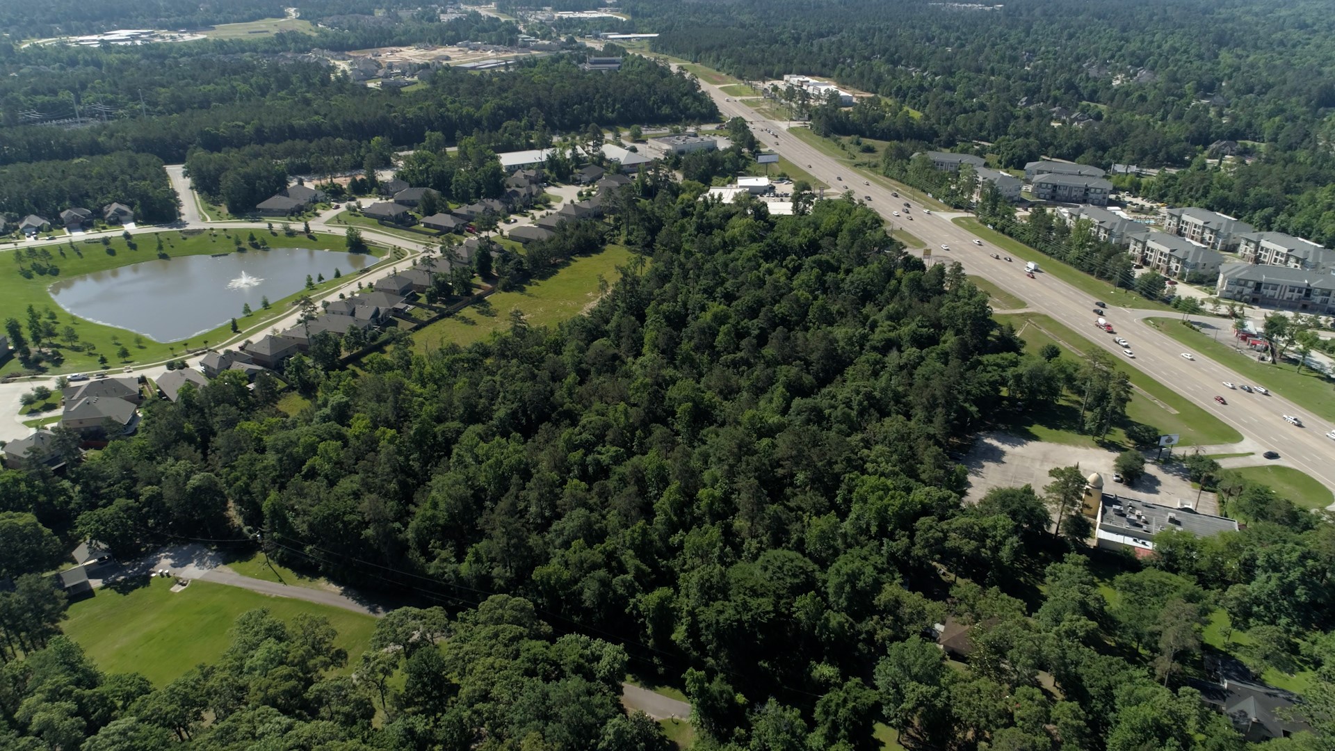 5030 West Davis Street Conroe, TX 77304 - Photo 13 of 13 an aerial view of residential houses with outdoor space and swimming pool