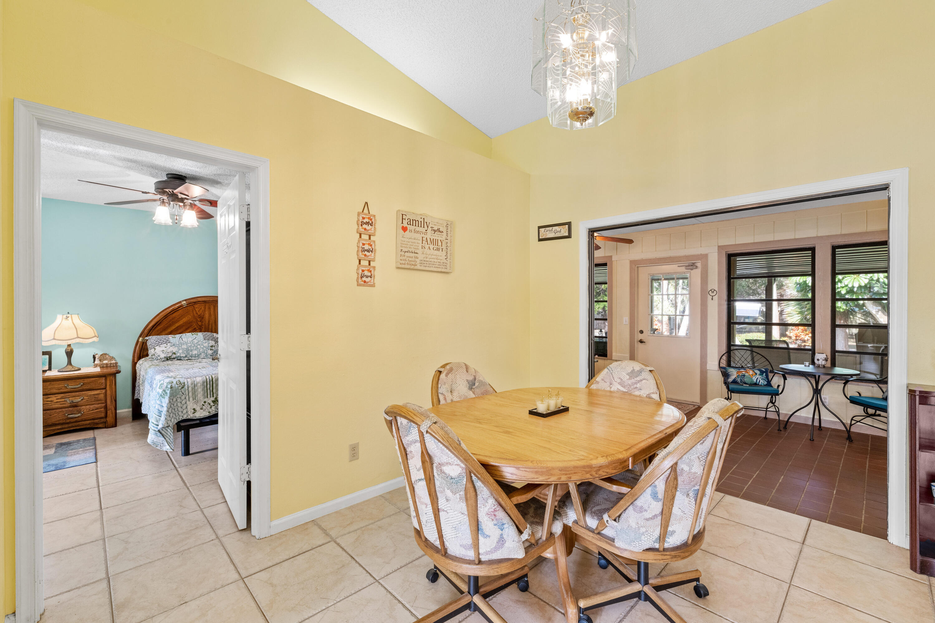16887 West Cornwall Drive Loxahatchee, FL 33470 - Photo 16 of 37 a view of a dining room with furniture and chandelier