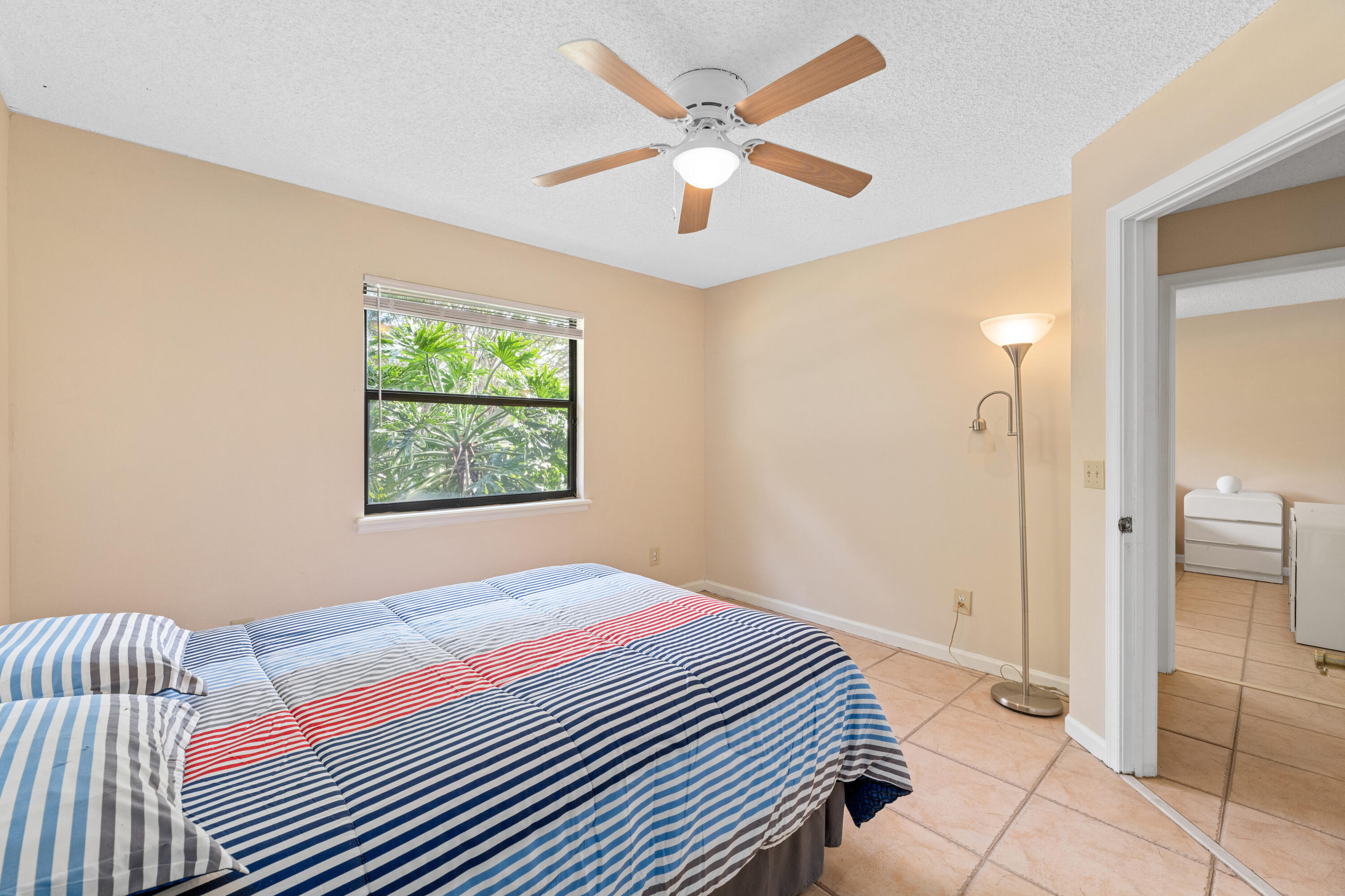 16887 West Cornwall Drive Loxahatchee, FL 33470 - Photo 21 of 37 a bedroom with a bed and a window