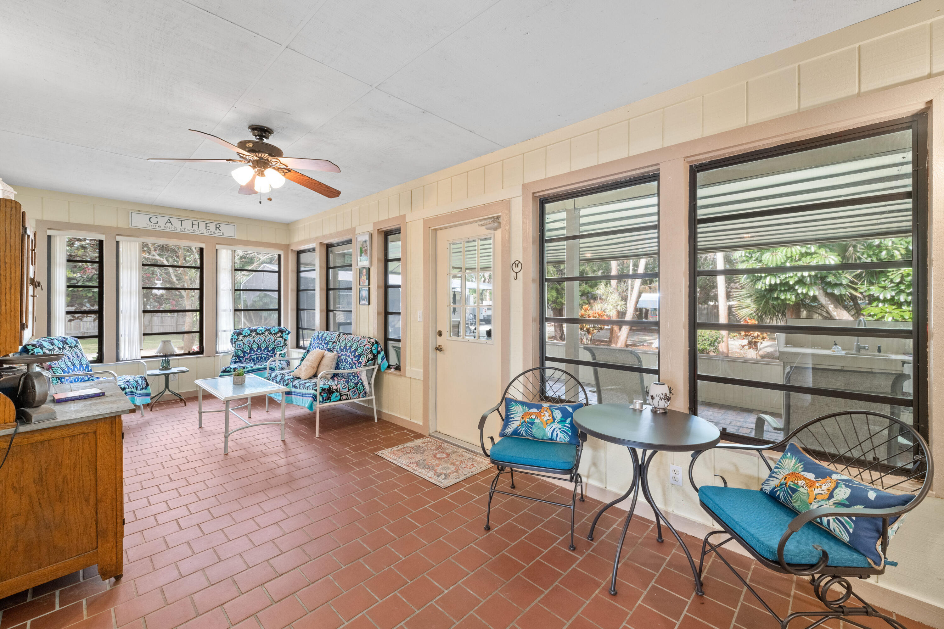 16887 West Cornwall Drive Loxahatchee, FL 33470 - Photo 22 of 37 a living room with furniture and floor to ceiling windows