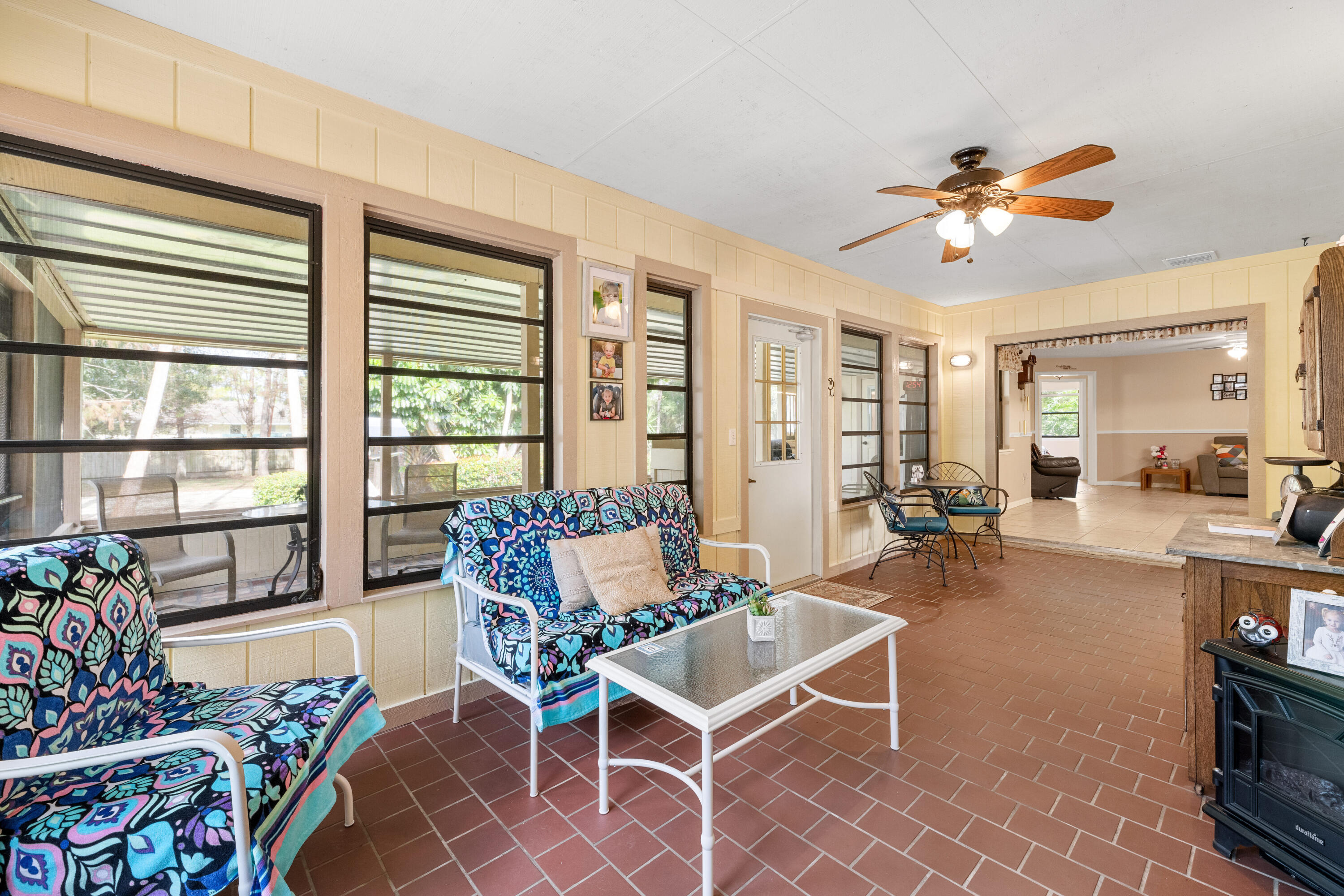 16887 West Cornwall Drive Loxahatchee, FL 33470 - Photo 24 of 37 a living room with furniture a dining table and a potted plant