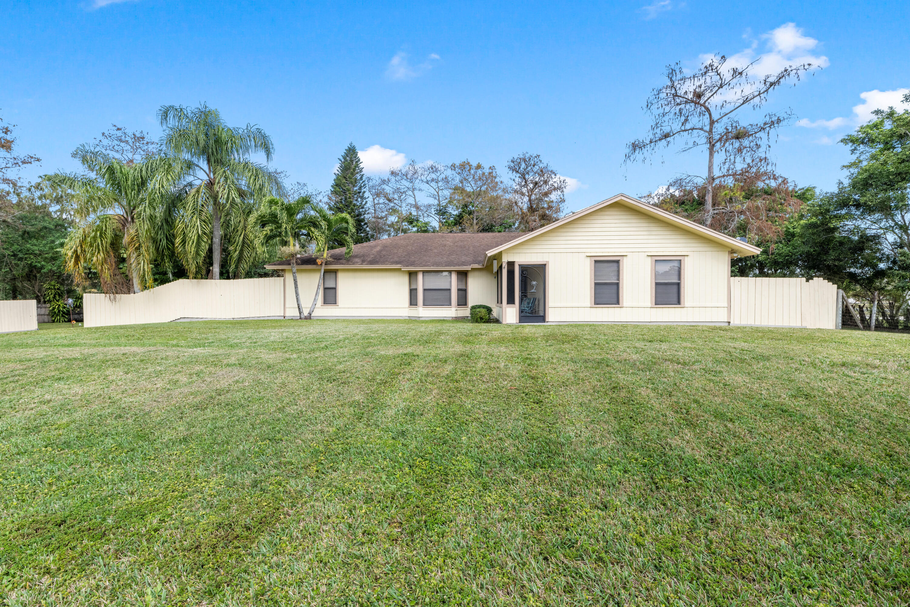 16887 West Cornwall Drive Loxahatchee, FL 33470 - Photo 28 of 37 a house view with a garden space