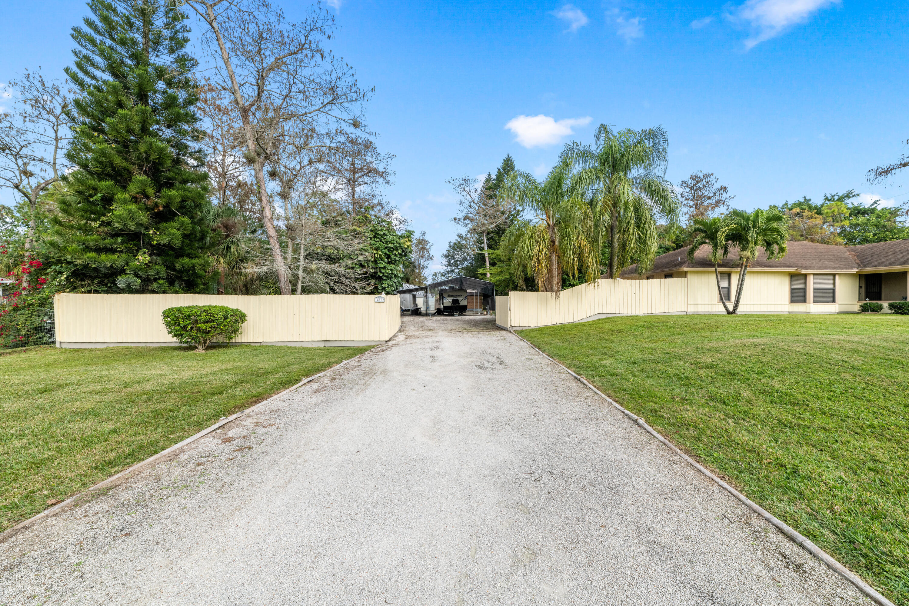 16887 West Cornwall Drive Loxahatchee, FL 33470 - Photo 30 of 37 a view of a house with a yard and a street
