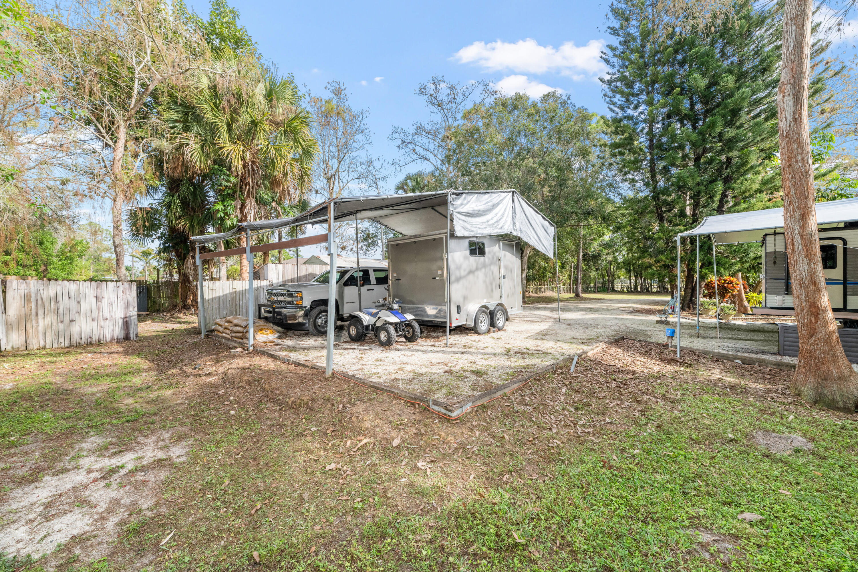 16887 West Cornwall Drive Loxahatchee, FL 33470 - Photo 31 of 37 a view of a house with a yard and large trees