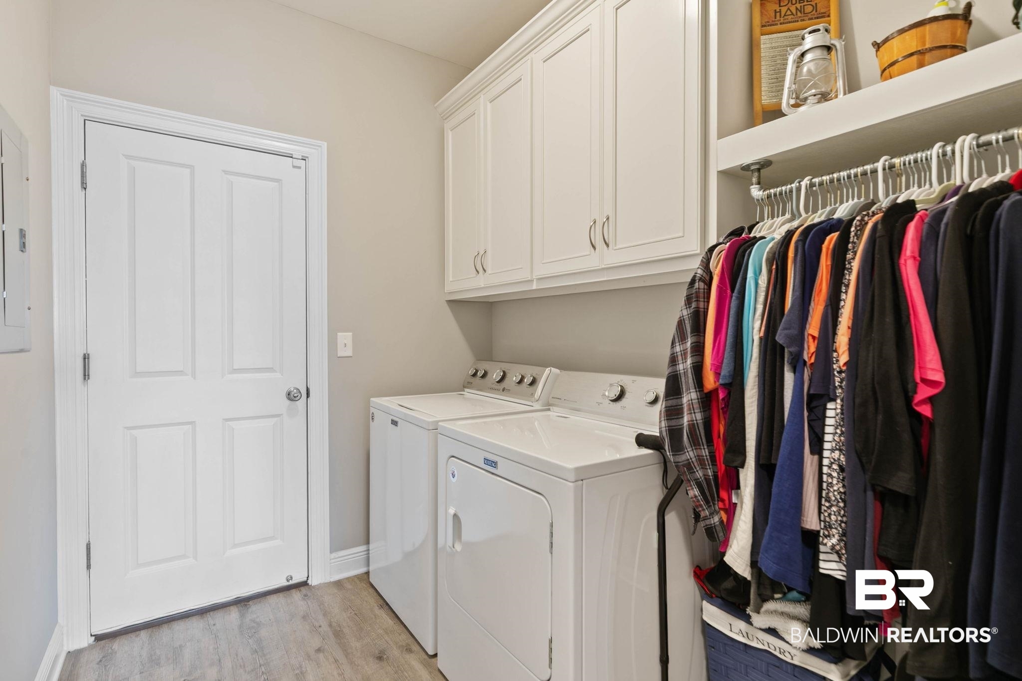9388 Pembrook Loop Fairhope, AL 36532 - Photo 39 of 53 Laundry room featuring washing machine and dryer, light wood finished floors, cabinet space, and electric panel