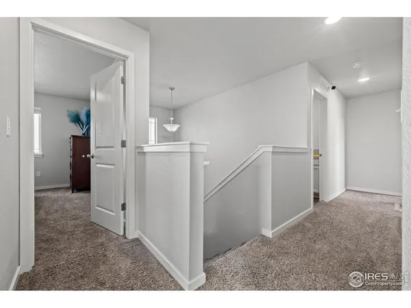 a spacious bedroom with a bed and a chandelier