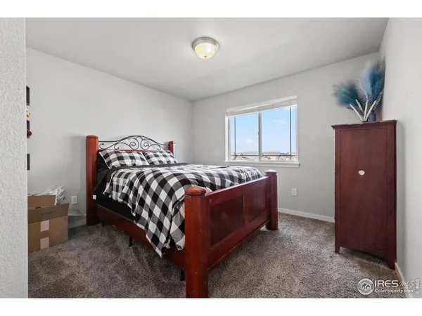 a bedroom with a bed and dresser