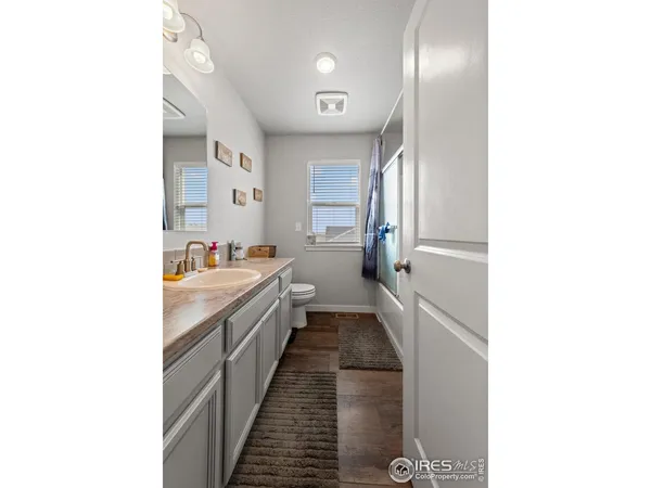 a living room with furniture a flat screen tv and a window