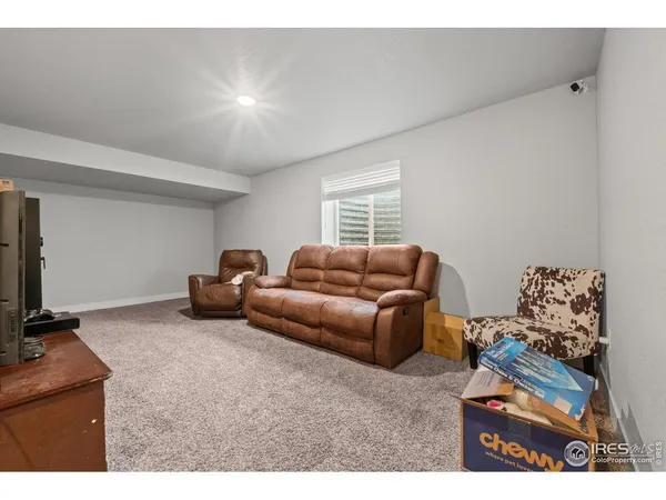 a view of a hallway with couches and living room