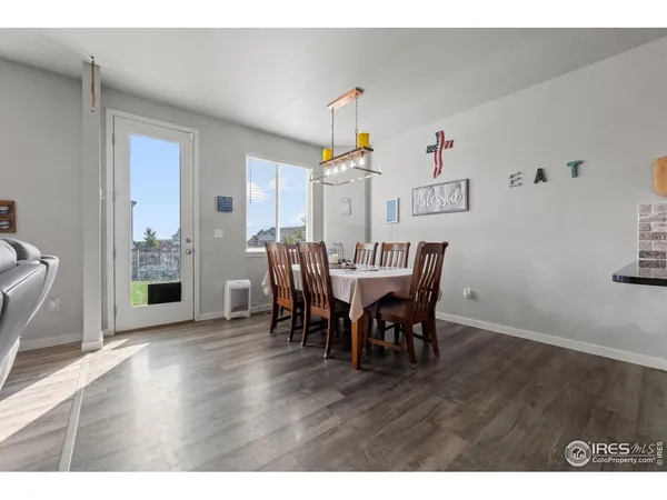 a kitchen with stainless steel appliances a sink cabinets and wooden floor