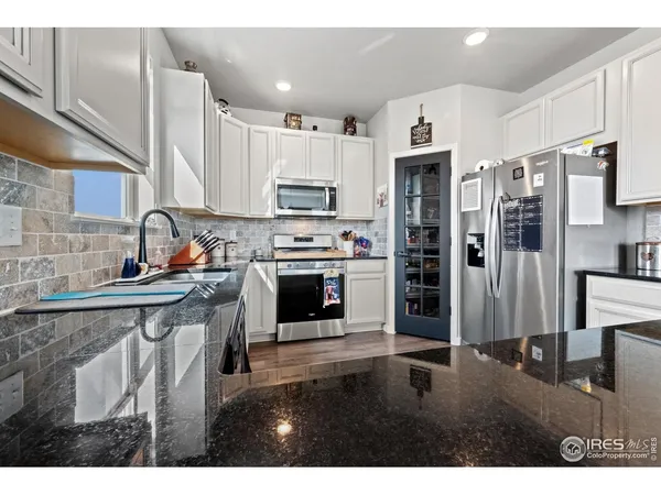 a kitchen with stainless steel appliances a refrigerator and cabinets