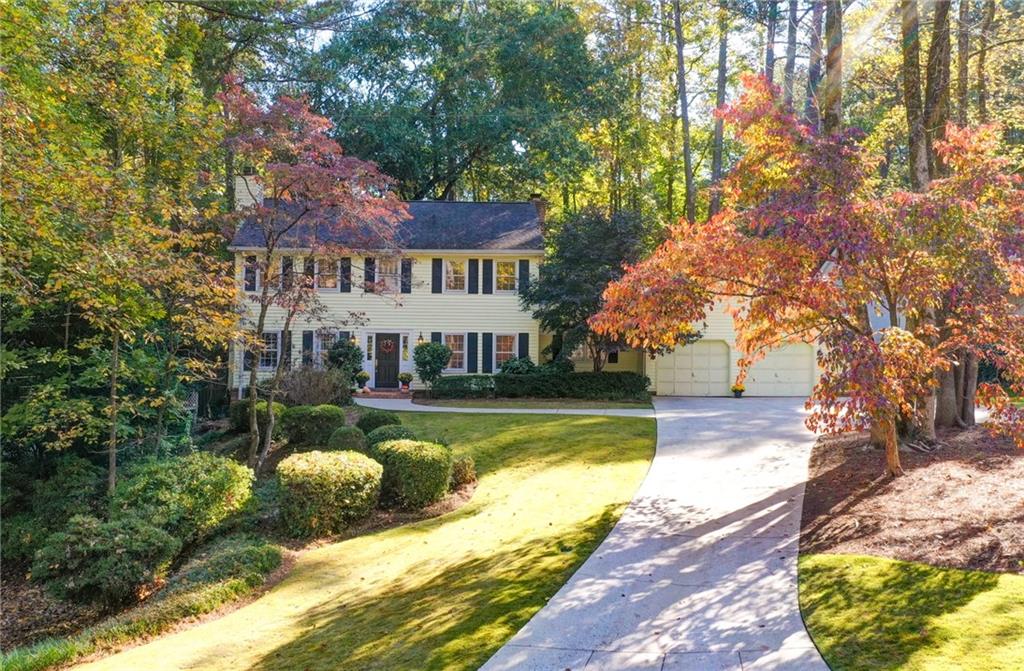 a view of a house with swimming pool and a yard