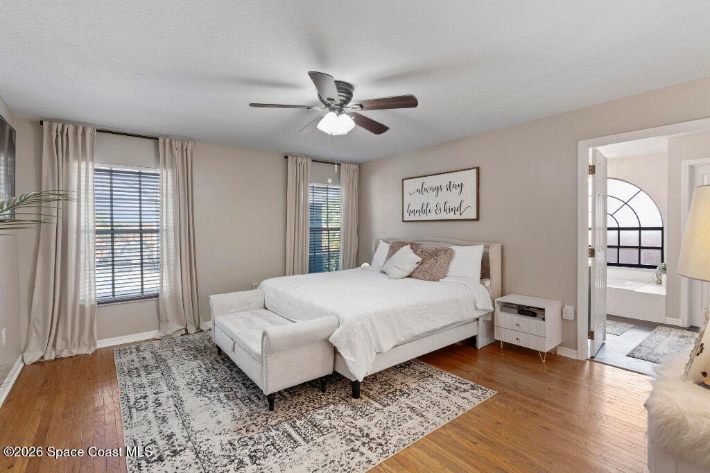 2639 Lowell Circle Melbourne, FL 32935 - Photo 19 of 45 a spacious bedroom with a bed and a window