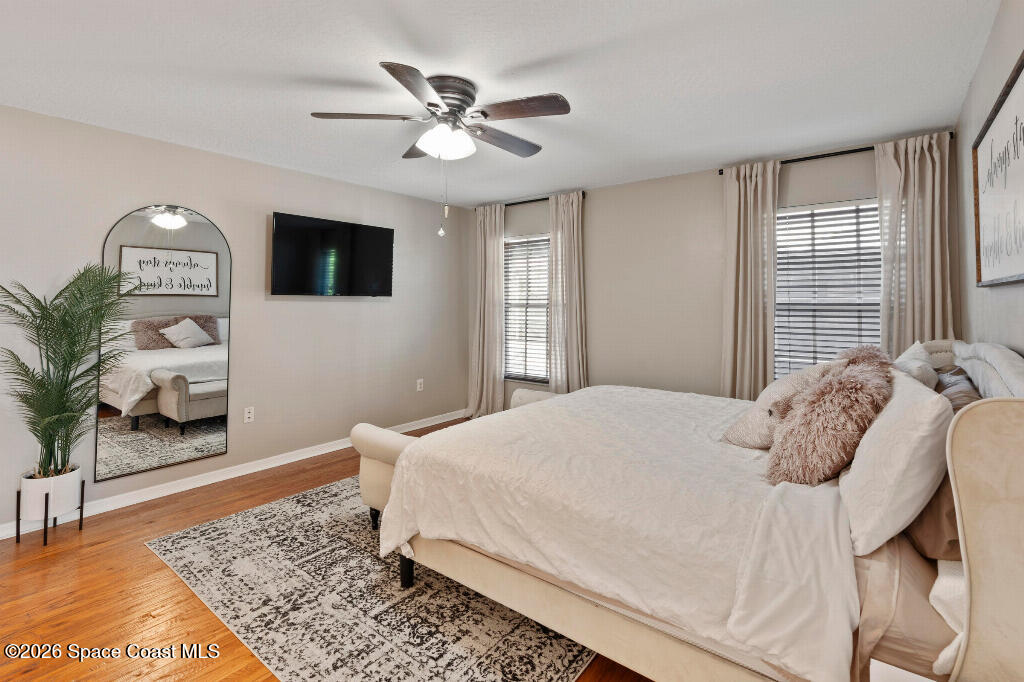 2639 Lowell Circle Melbourne, FL 32935 - Photo 20 of 45 a bedroom with a large bed and a window