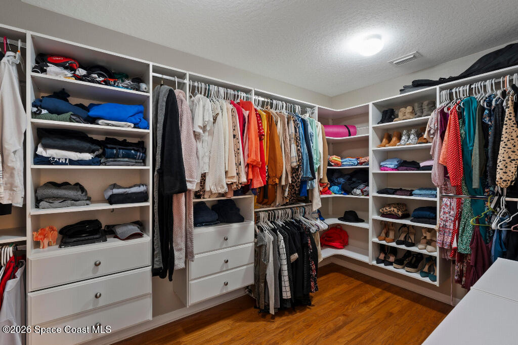 2639 Lowell Circle Melbourne, FL 32935 - Photo 24 of 45 a view of walk in closet with clothes and shoes