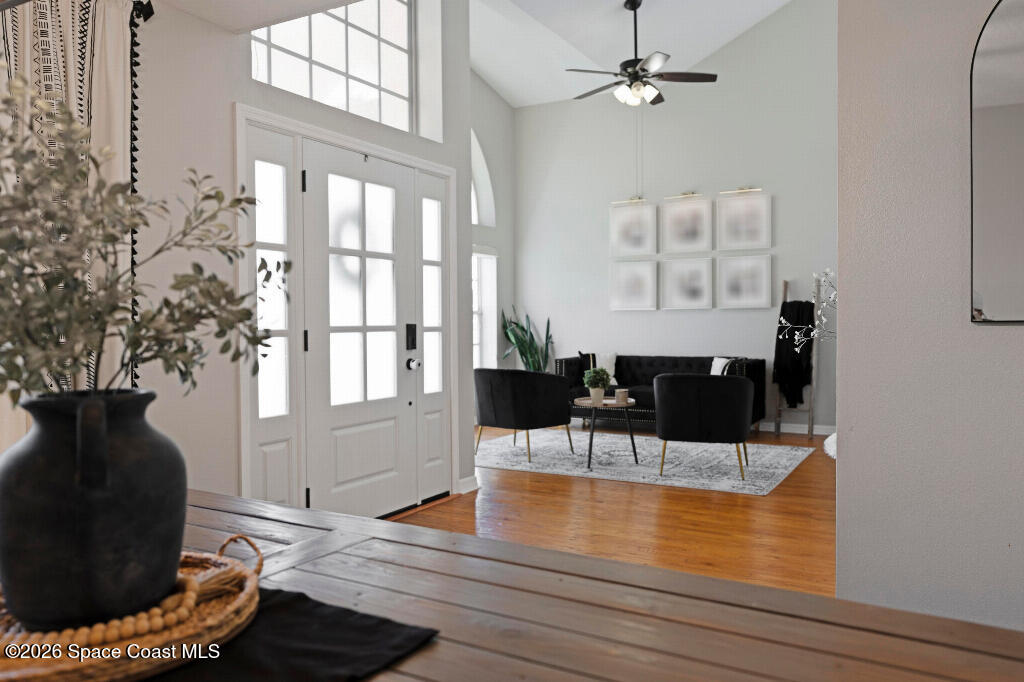 2639 Lowell Circle Melbourne, FL 32935 - Photo 3 of 45 a dining room with wooden floor and a chandelier