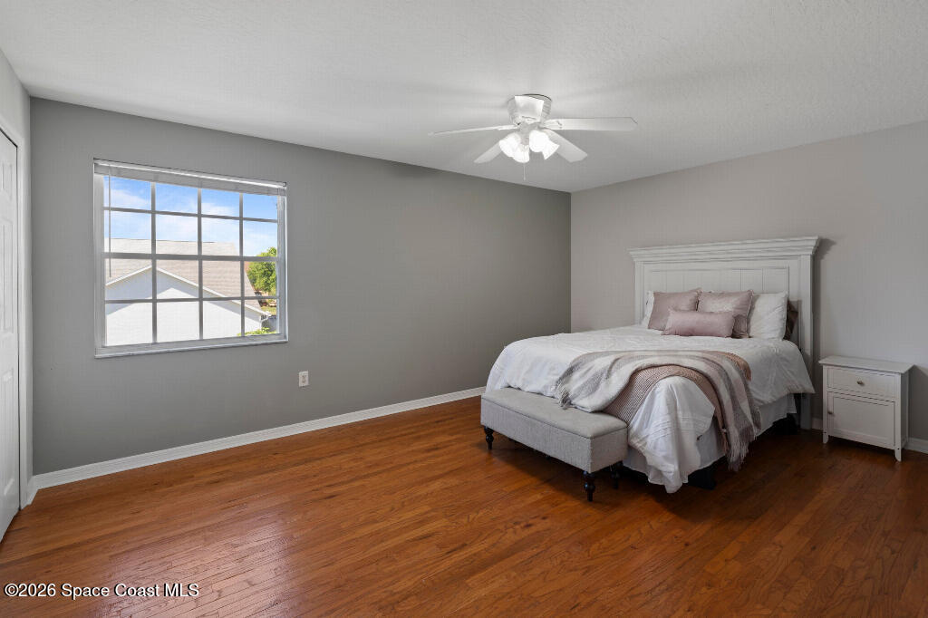 2639 Lowell Circle Melbourne, FL 32935 - Photo 32 of 45 a bedroom with a bed and a chandelier