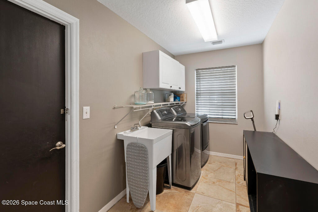 2639 Lowell Circle Melbourne, FL 32935 - Photo 36 of 45 a kitchen with stainless steel appliances granite countertop a stove a sink and a refrigerator