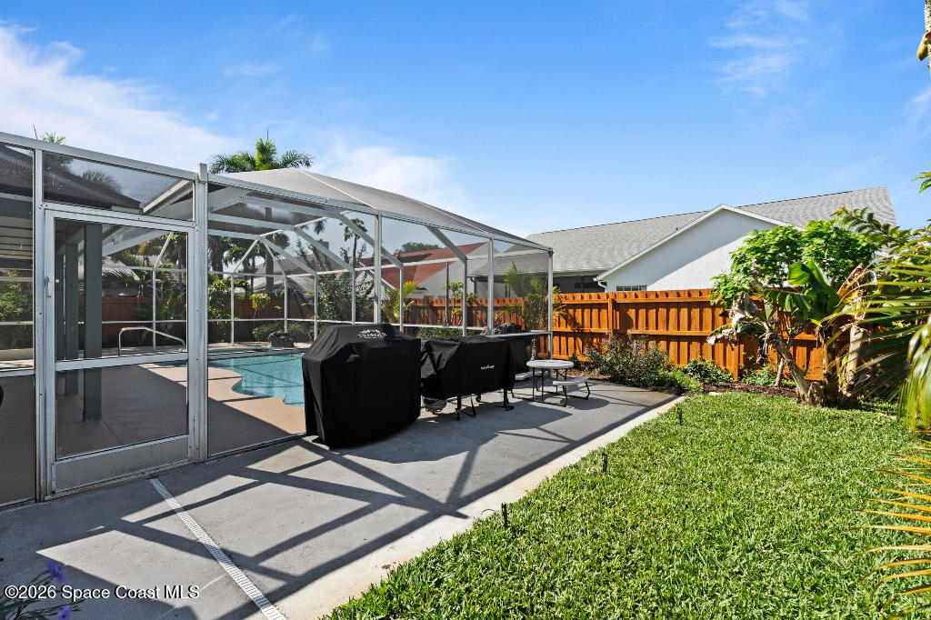 2639 Lowell Circle Melbourne, FL 32935 - Photo 41 of 45 a view of a patio with table and chairs potted plants with wooden floor and fence