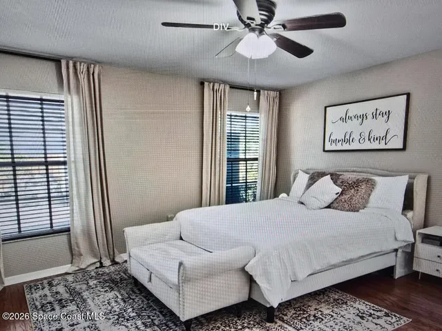 a bedroom with a large bed and a window