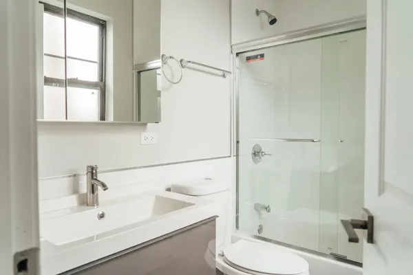 a bathroom with a sink toilet and shower