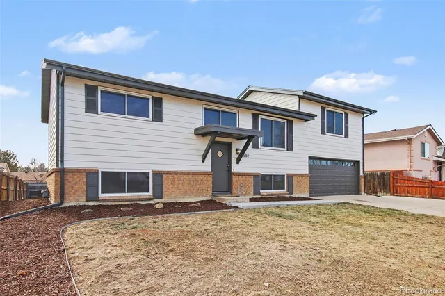 an empty room with fireplace and windows