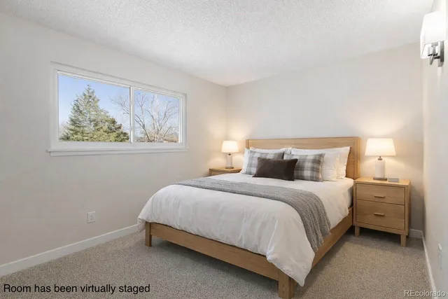 a bedroom with a bed and a wall painting