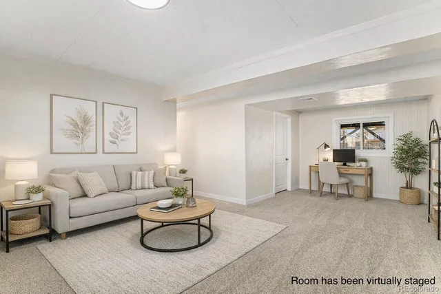 a living room with furniture and a potted plant