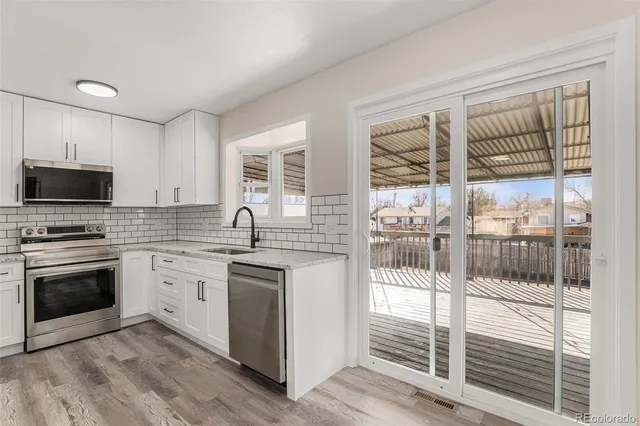 a kitchen with a sink and stainless steel appliances
