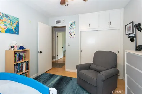 a bedroom with a bed and flat screen tv