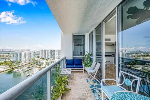 a balcony with furniture and a potted plant