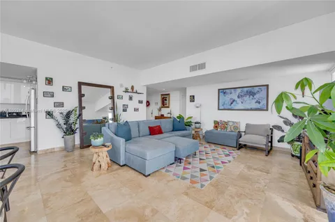 a living room with furniture and flowers