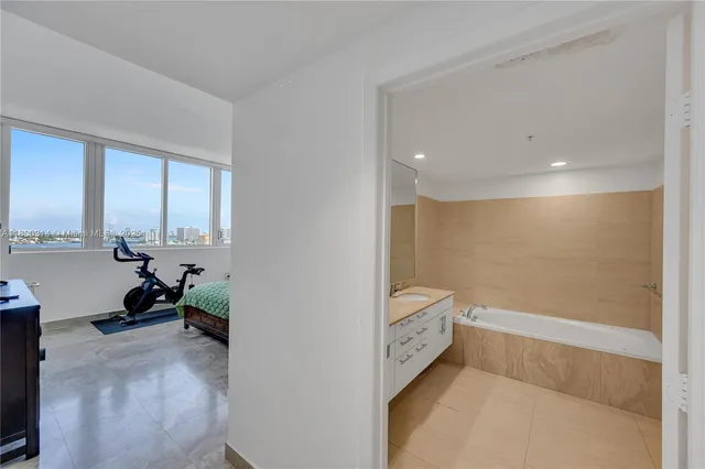 a reading room with furniture and a potted plant