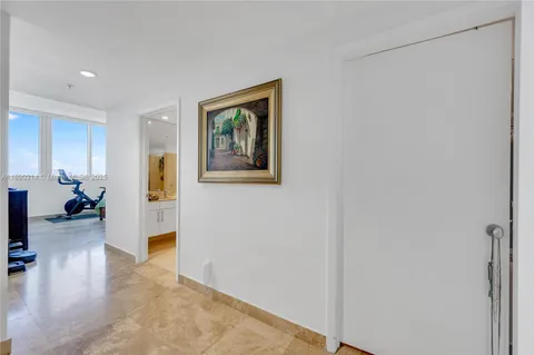 a bedroom with a bed windows and a large window