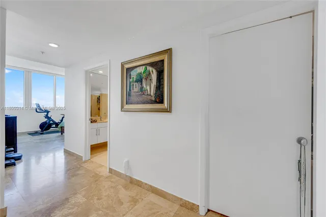 a bedroom with a bed windows and a large window