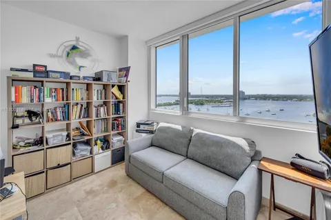 a bedroom with a bed and a flat tv screen on the dresser