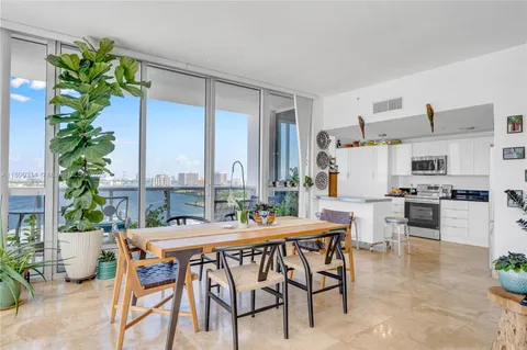 a dining room with furniture and a potted plant