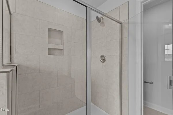 a bathroom with a glass door shower
