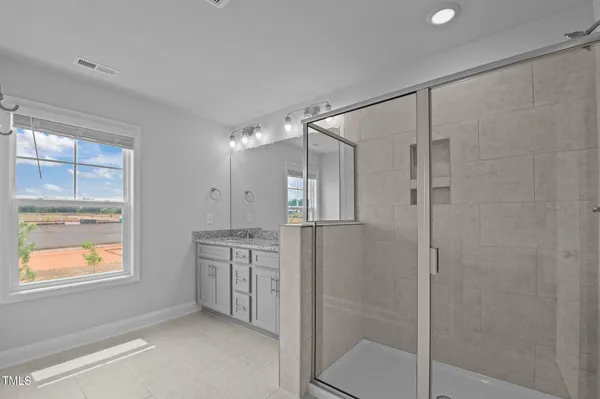 a bathroom with a shower and a sink